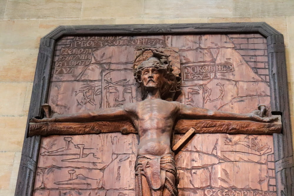 a wooden crucifix with a carving of jesus on it