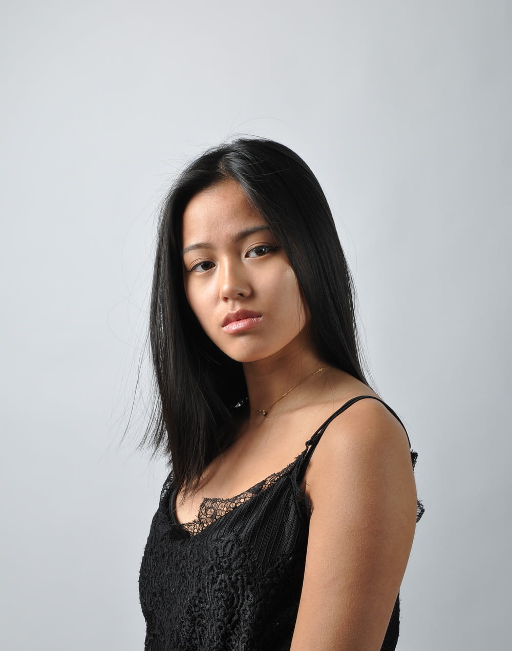an asian woman in a black dress posing for a picture