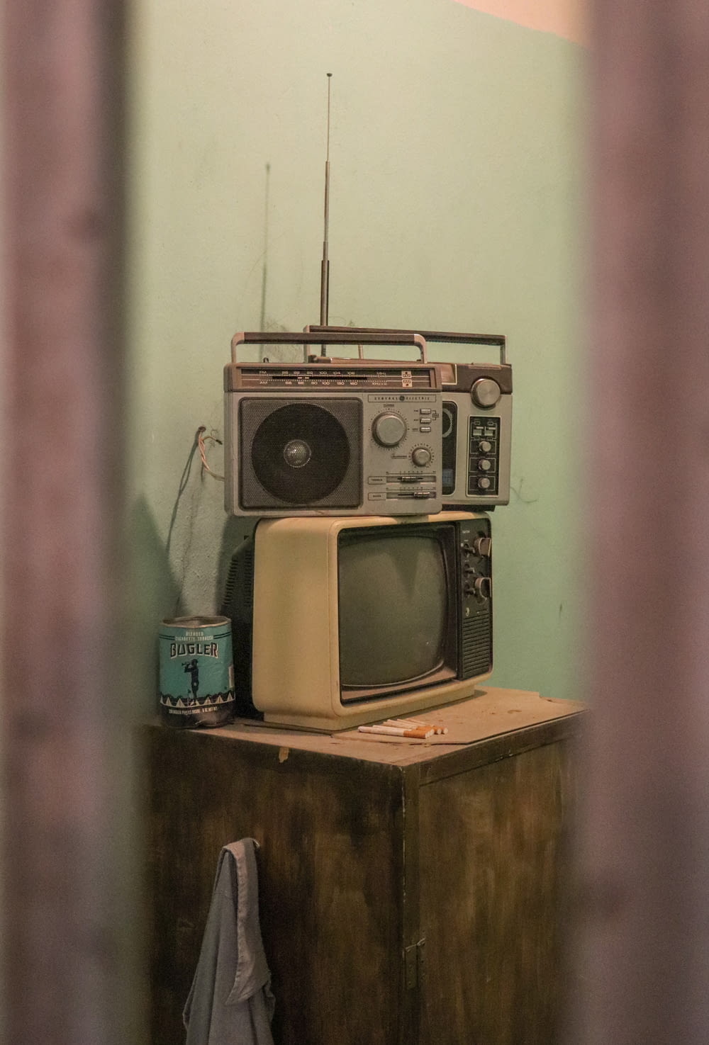 an old fashioned tv sitting on top of a wooden table