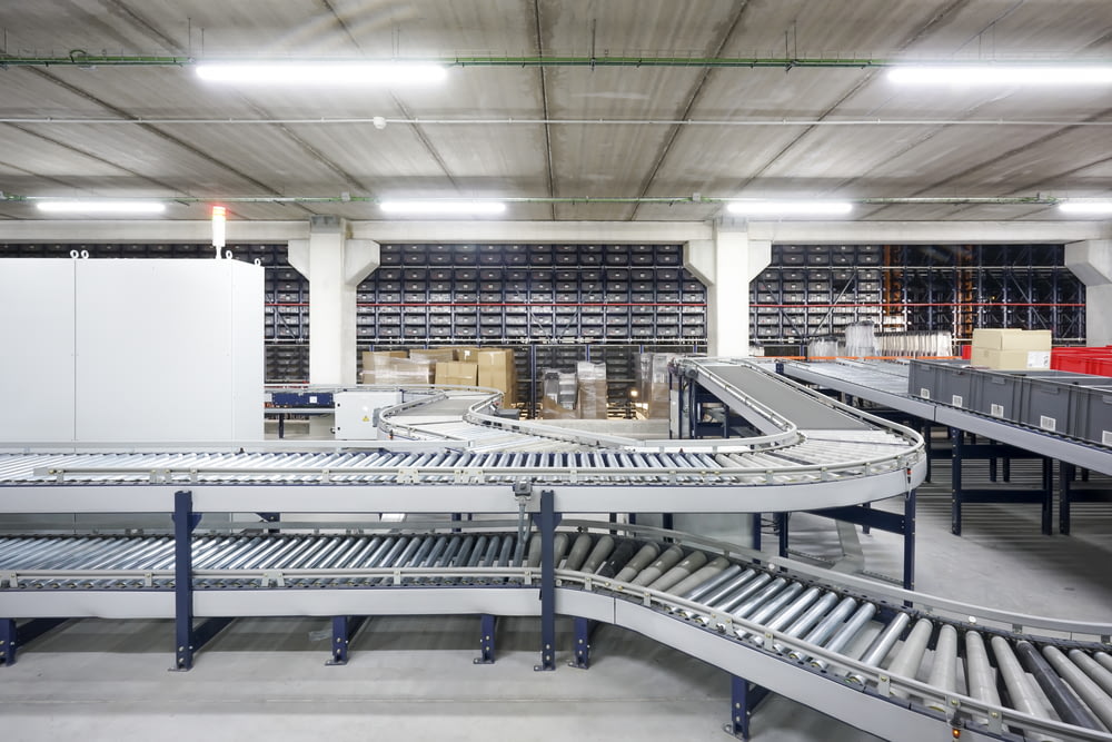 a conveyor belt in a large warehouse