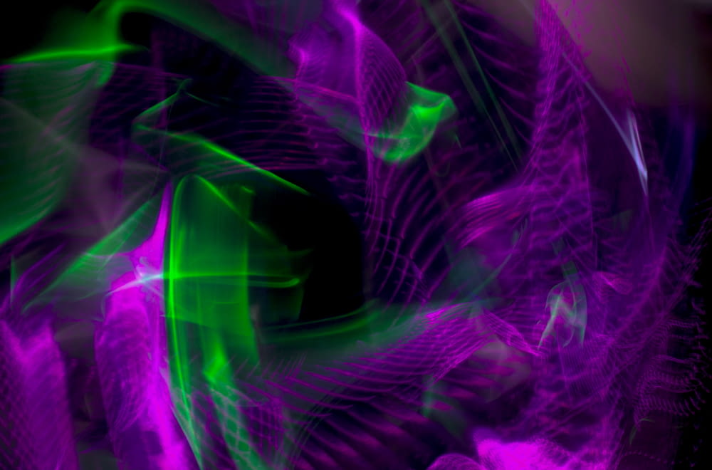 a purple and green abstract background with a black background