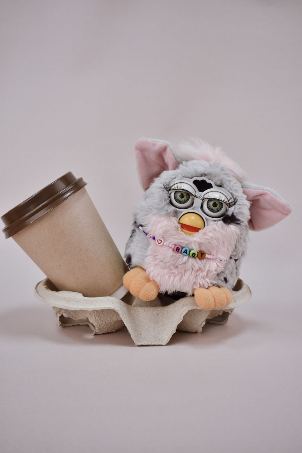 a stuffed animal holding a cup of coffee