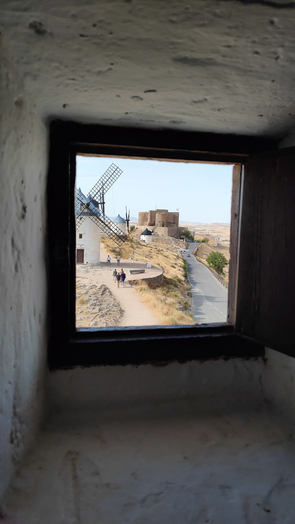 a window with a view of a windmill