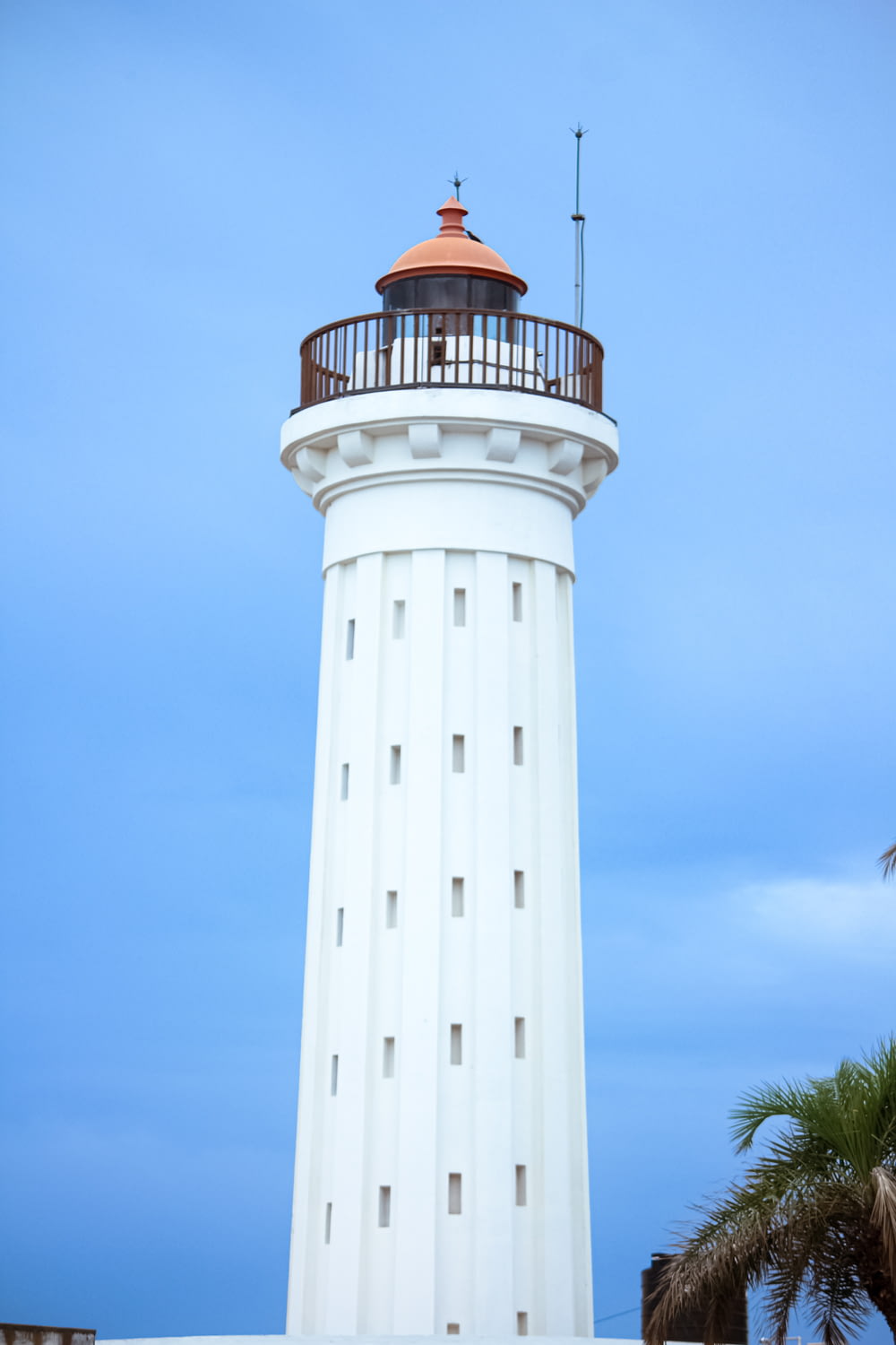 a tall white tower with a red top