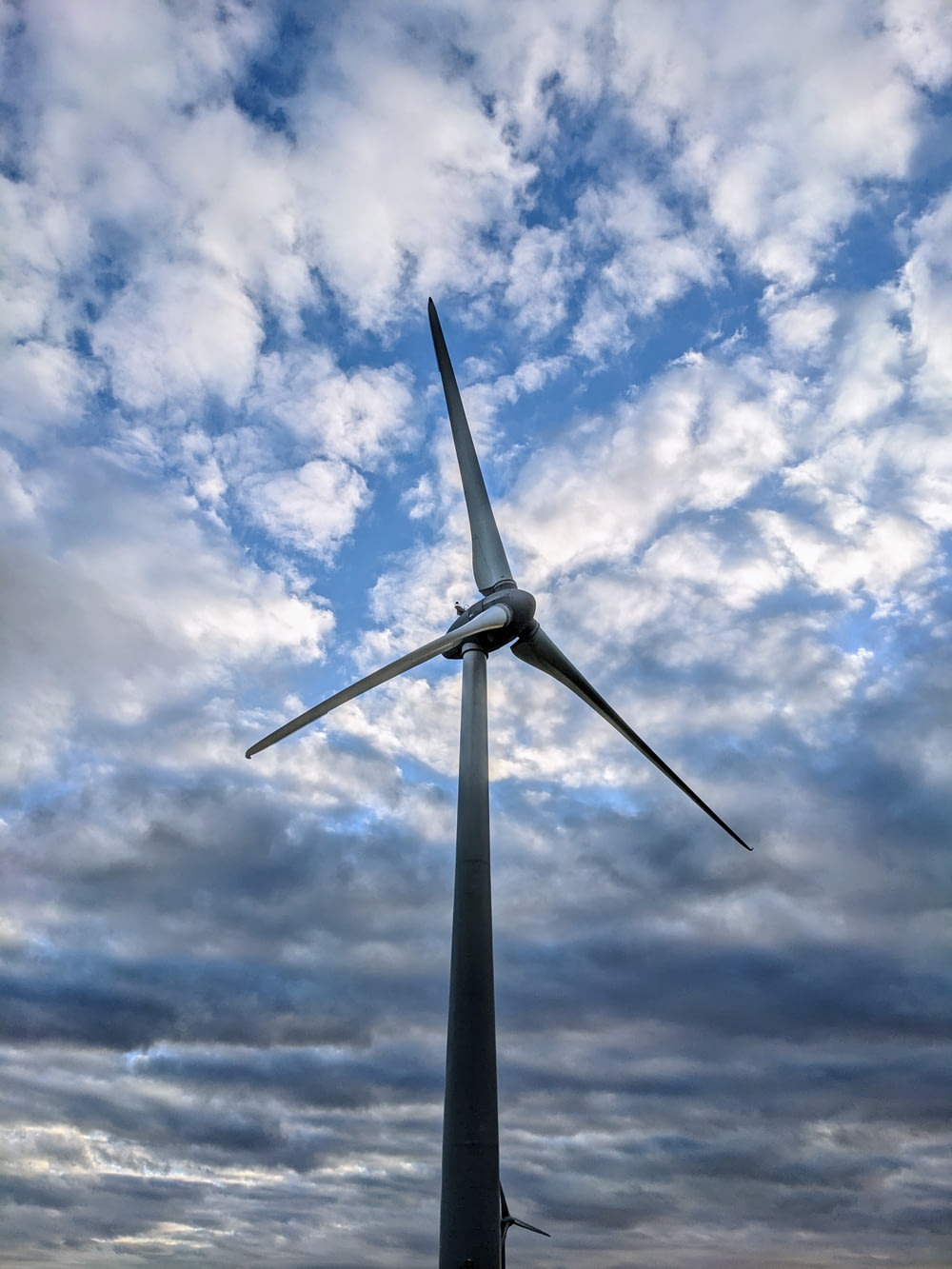 a large wind turbine on a cloudy day