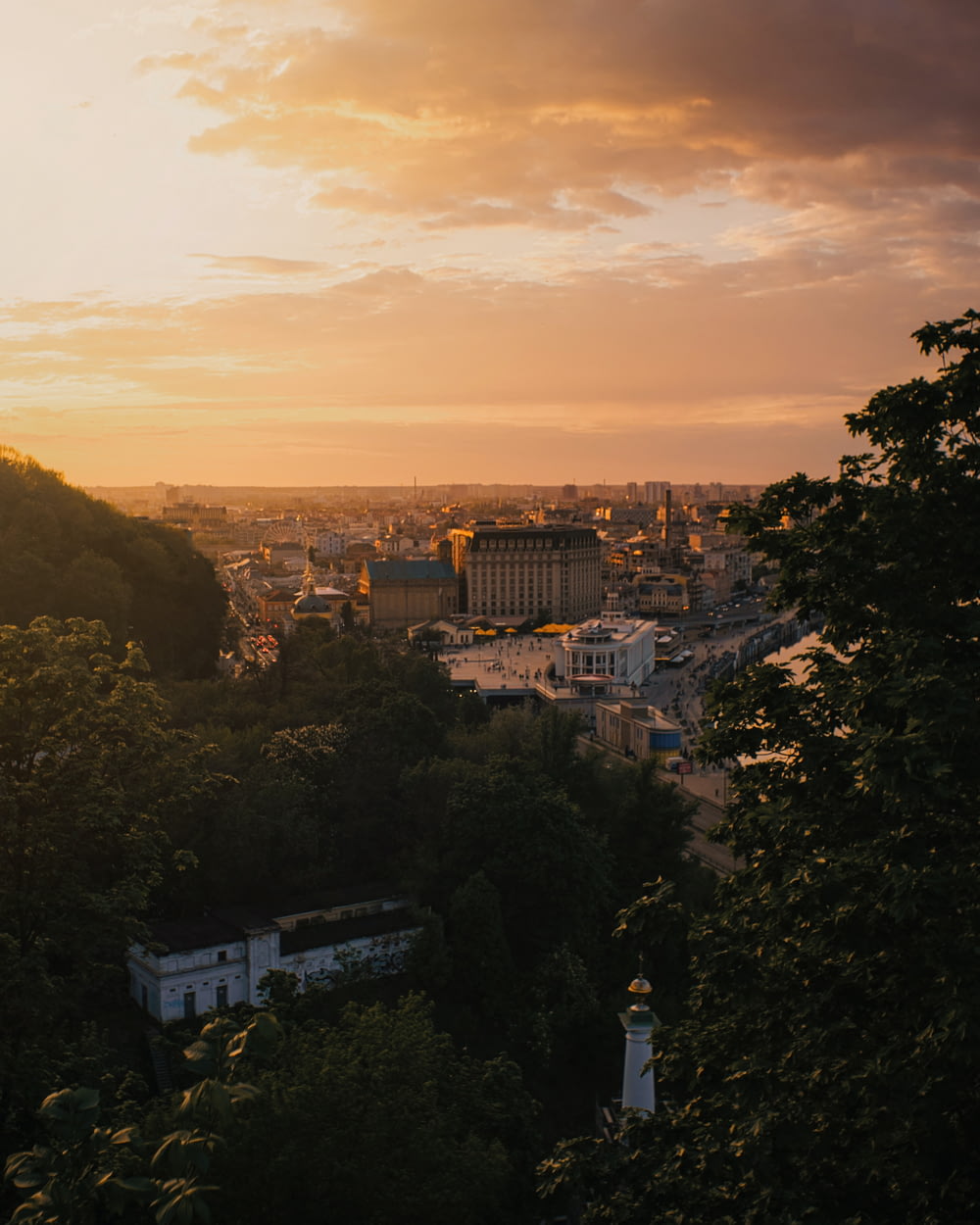 a view of a city from a hill at sunset