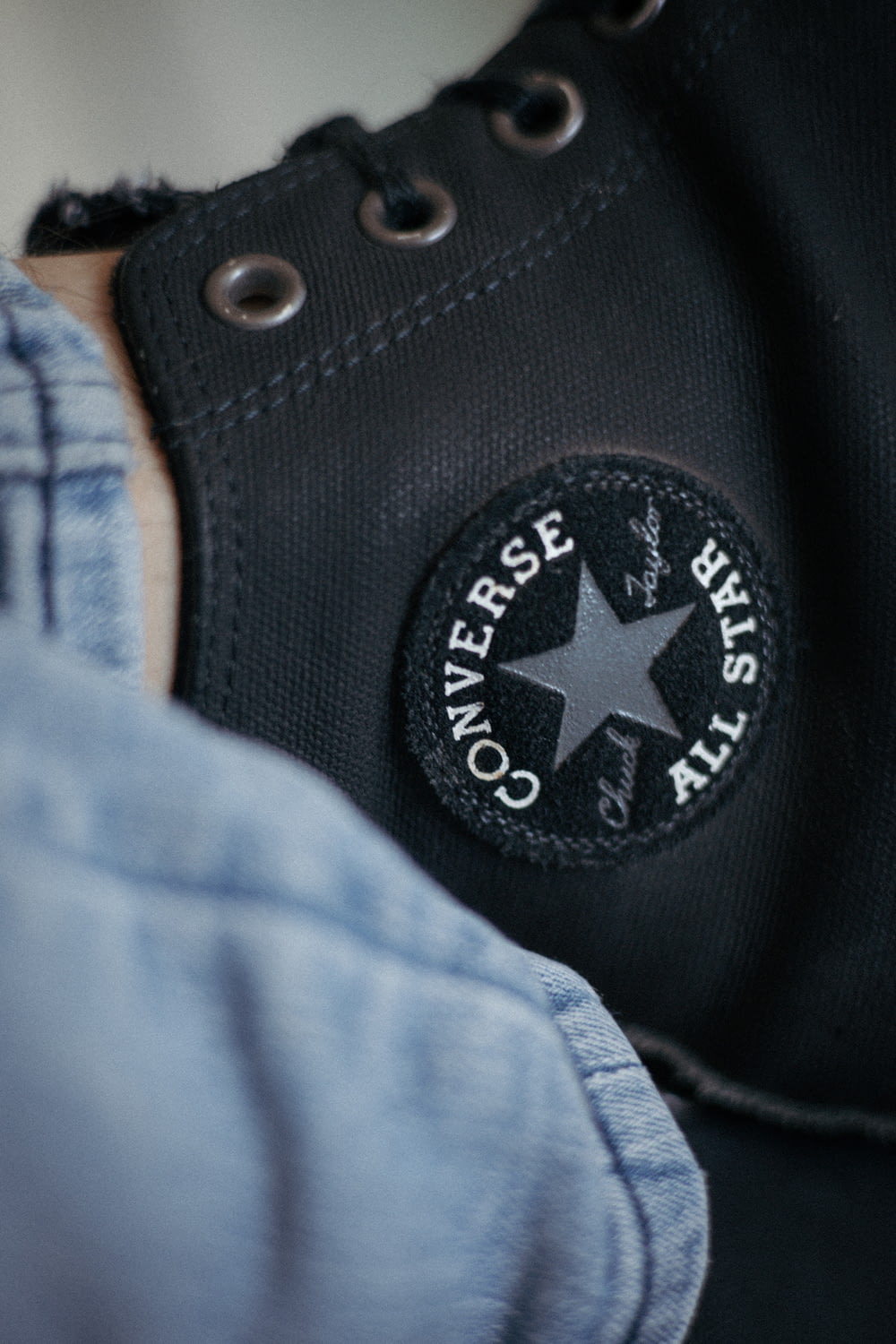 a pair of black converse shoes with a star on the side