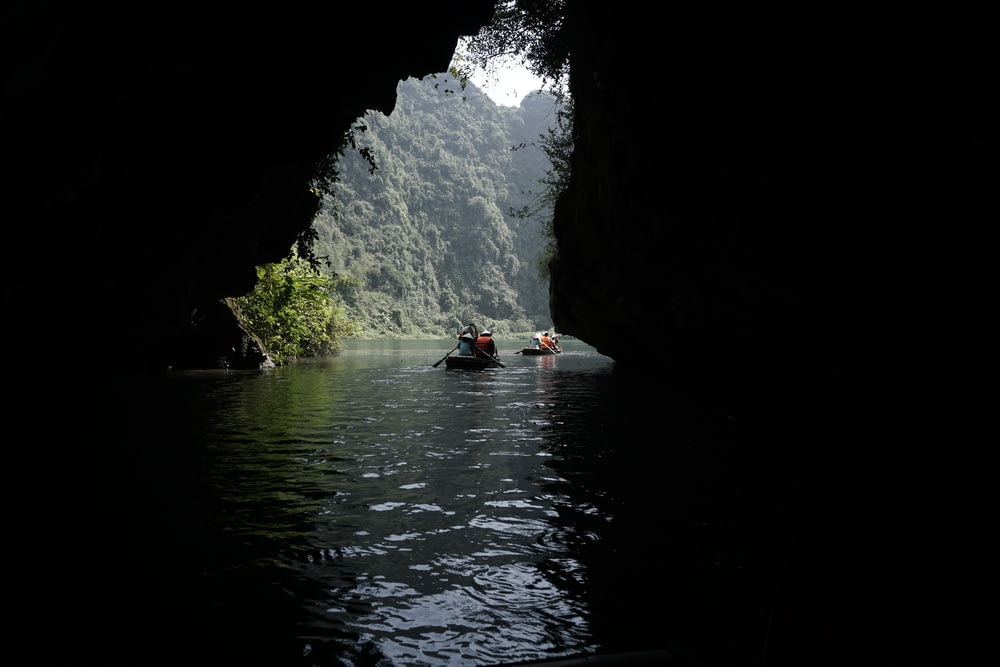 a group of people in a canoe in a cave
