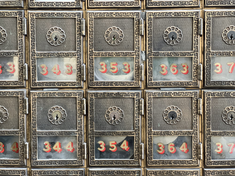 a bunch of mail boxes with numbers on them
