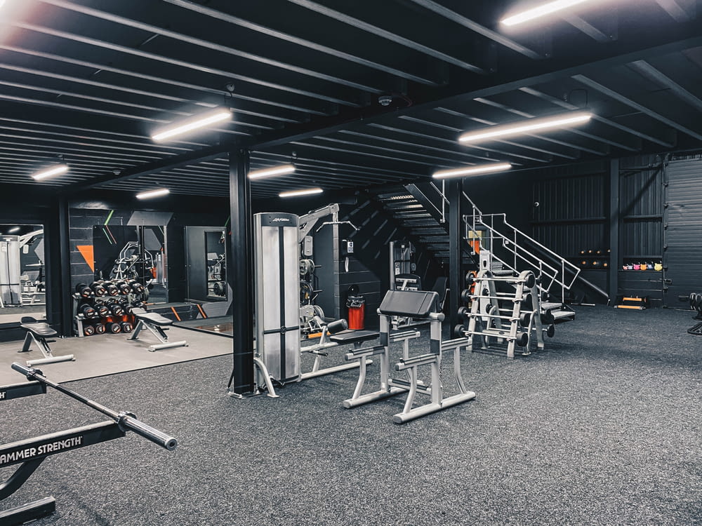 a gym filled with lots of machines and equipment