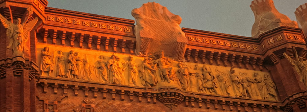 a large building with statues on the side of it