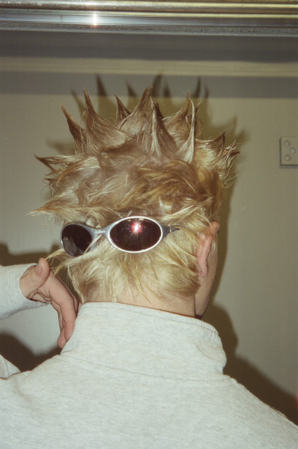 a person with a spiked head and sunglasses