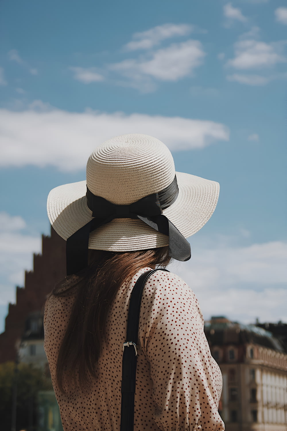 a woman wearing a hat and a backpack