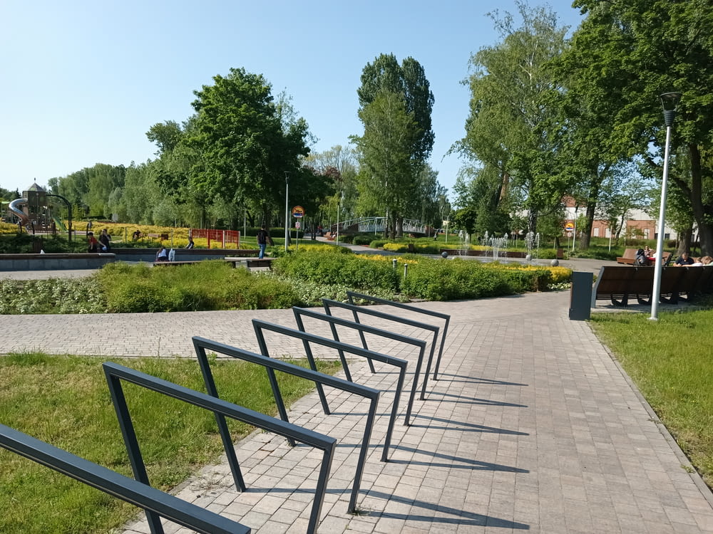 a row of benches sitting on top of a brick walkway