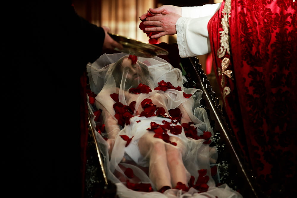 a woman in a wedding dress laying on the floor