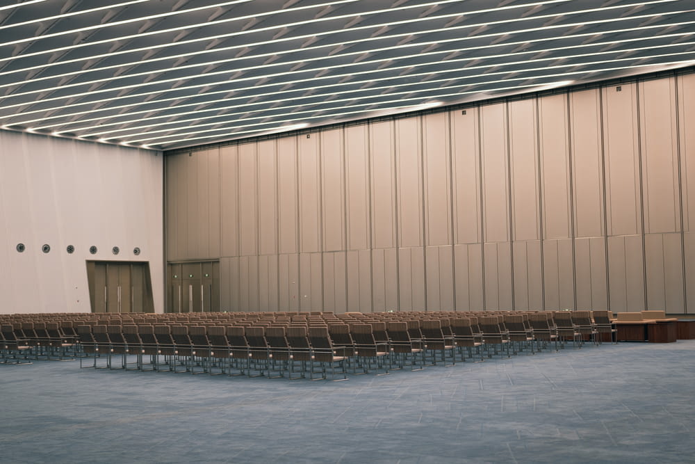 an empty auditorium with rows of empty chairs