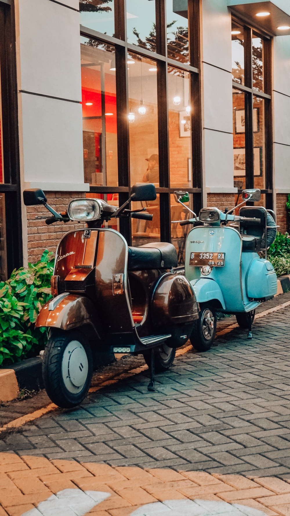 a row of mopeds parked next to each other in front of a building