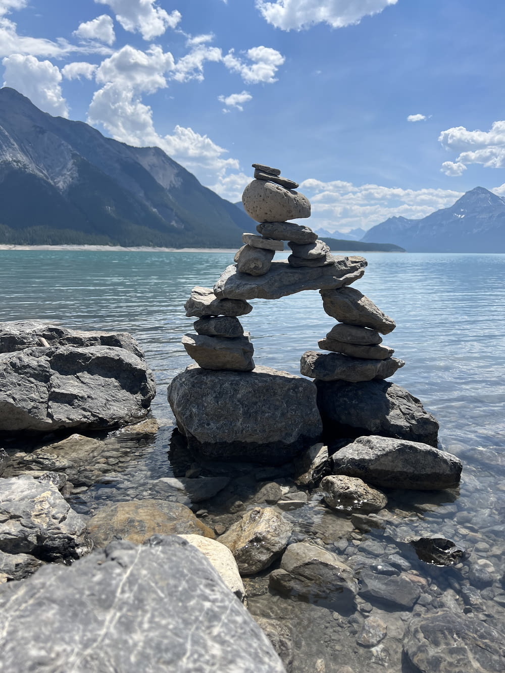 a stack of rocks sitting on top of a lake