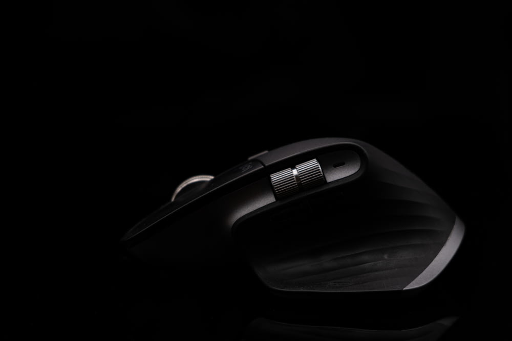 a close up of a mouse on a black surface