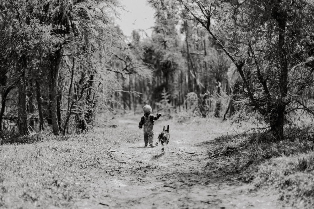 a black and white photo of a person and a dog