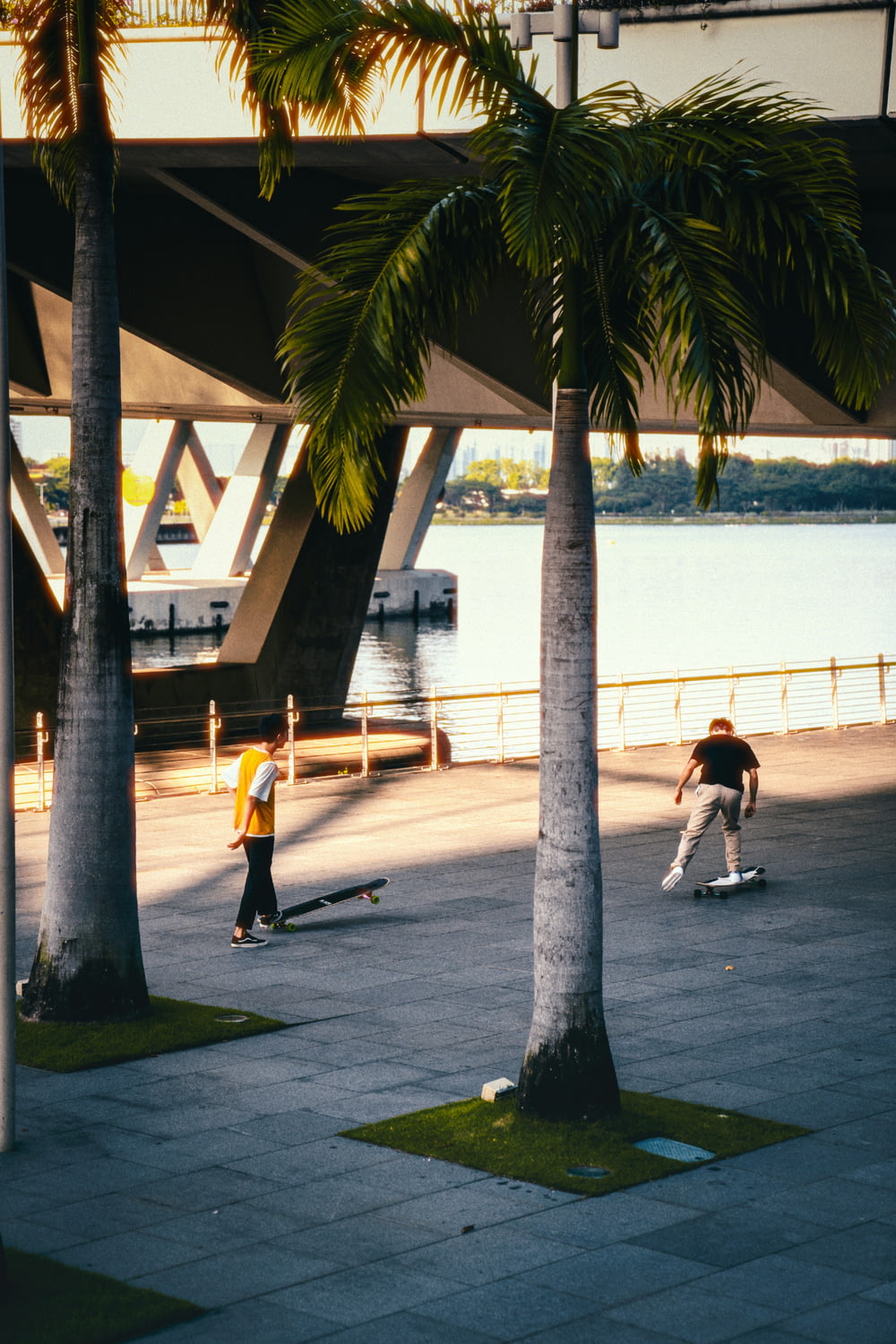 a group of people riding skateboards down a sidewalk