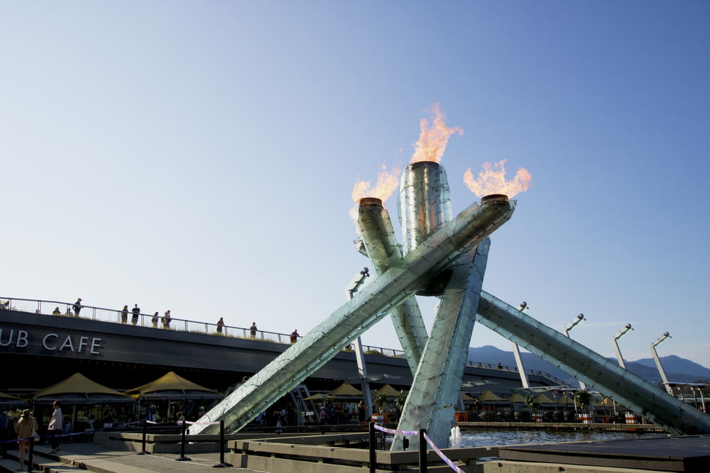 a large metal structure with flames on top of it