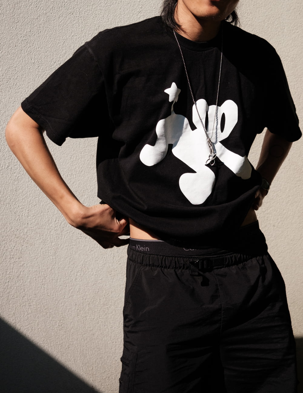 a man wearing a mickey mouse t - shirt