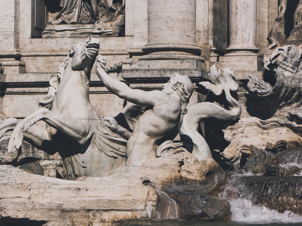a close up of a fountain with statues on it