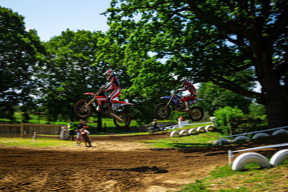 a couple of people on dirt bikes in the air