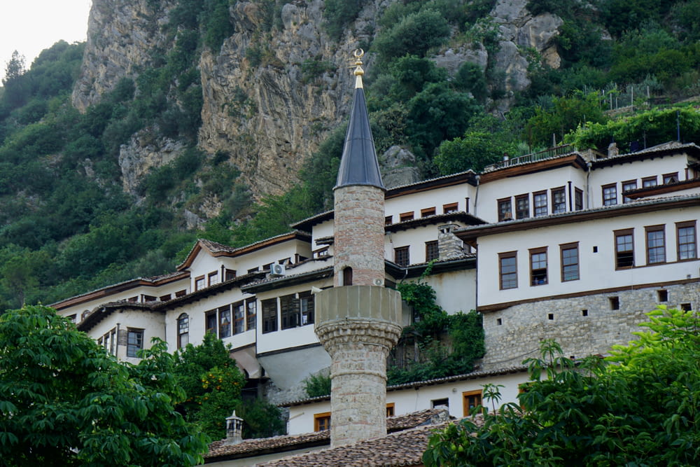 a building with a steeple on the side of a mountain