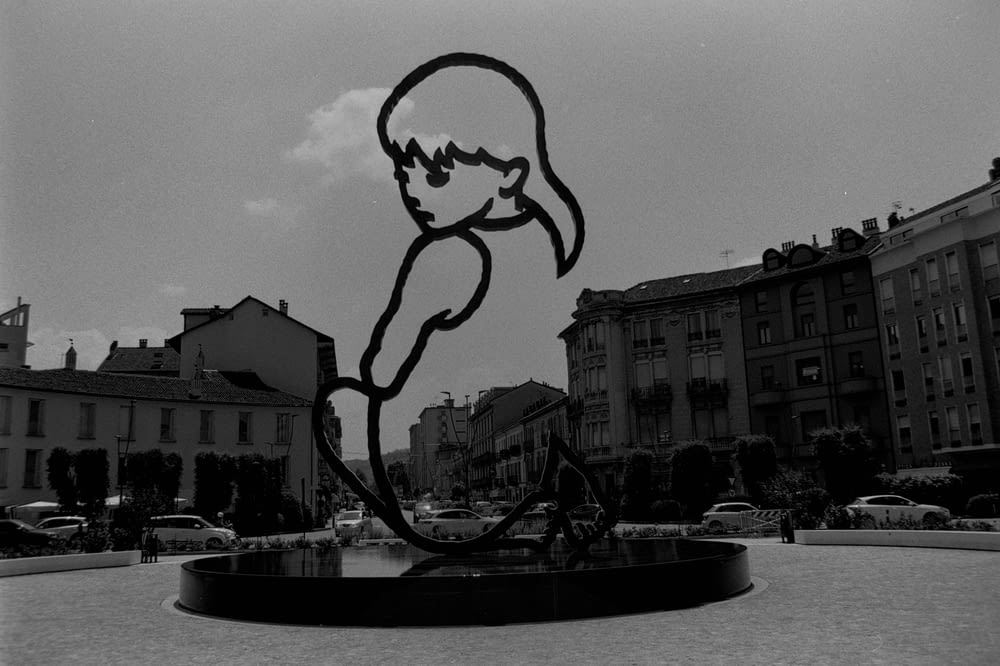 a black and white photo of a statue of a person