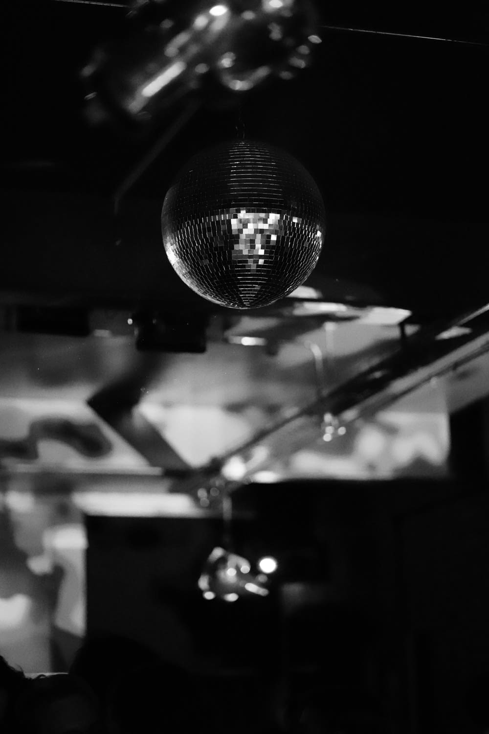 a disco ball hanging from the ceiling in a dark room