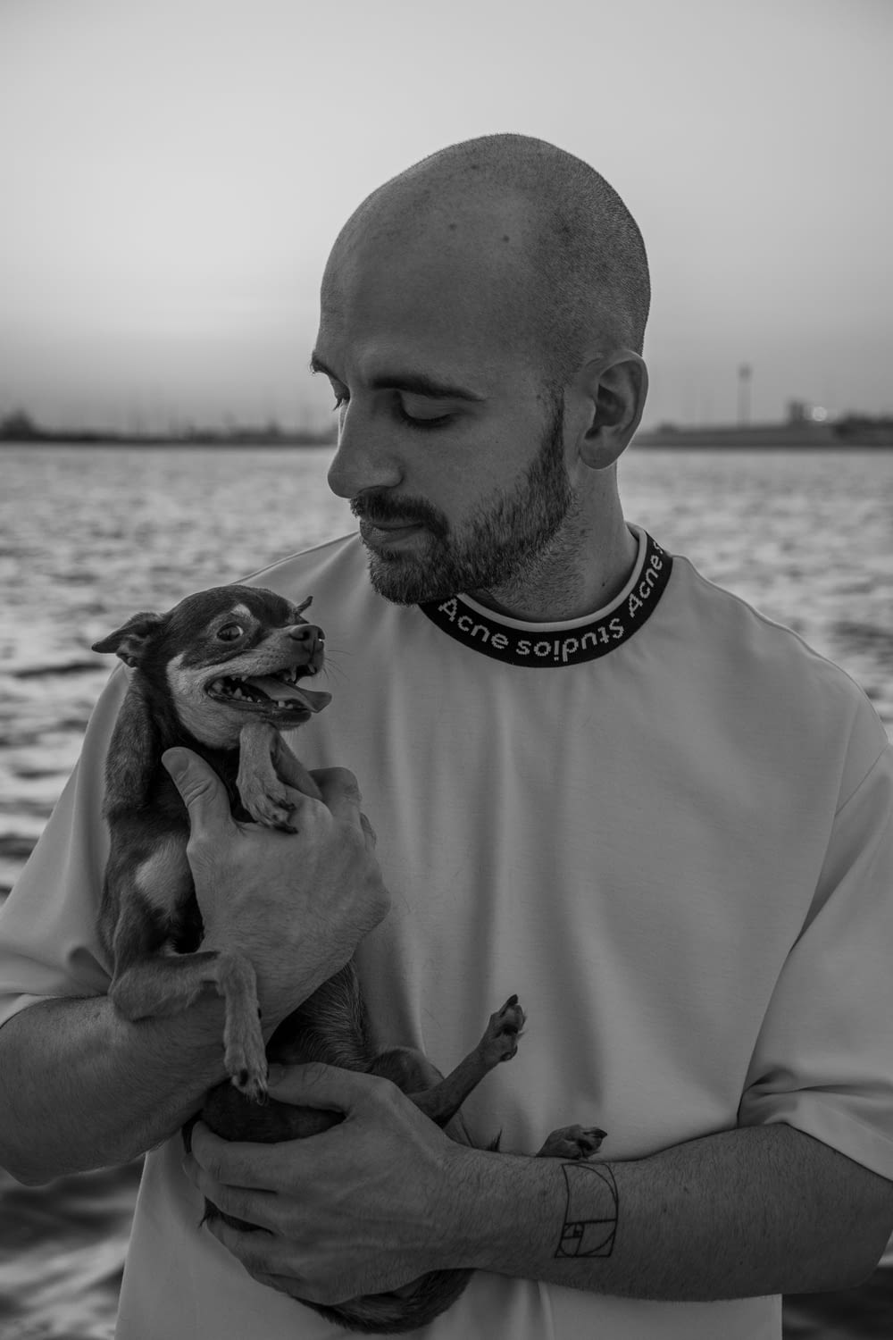 a man holding a small dog in his hands
