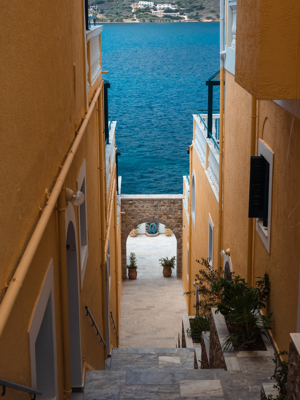 a narrow alley way leading to a body of water