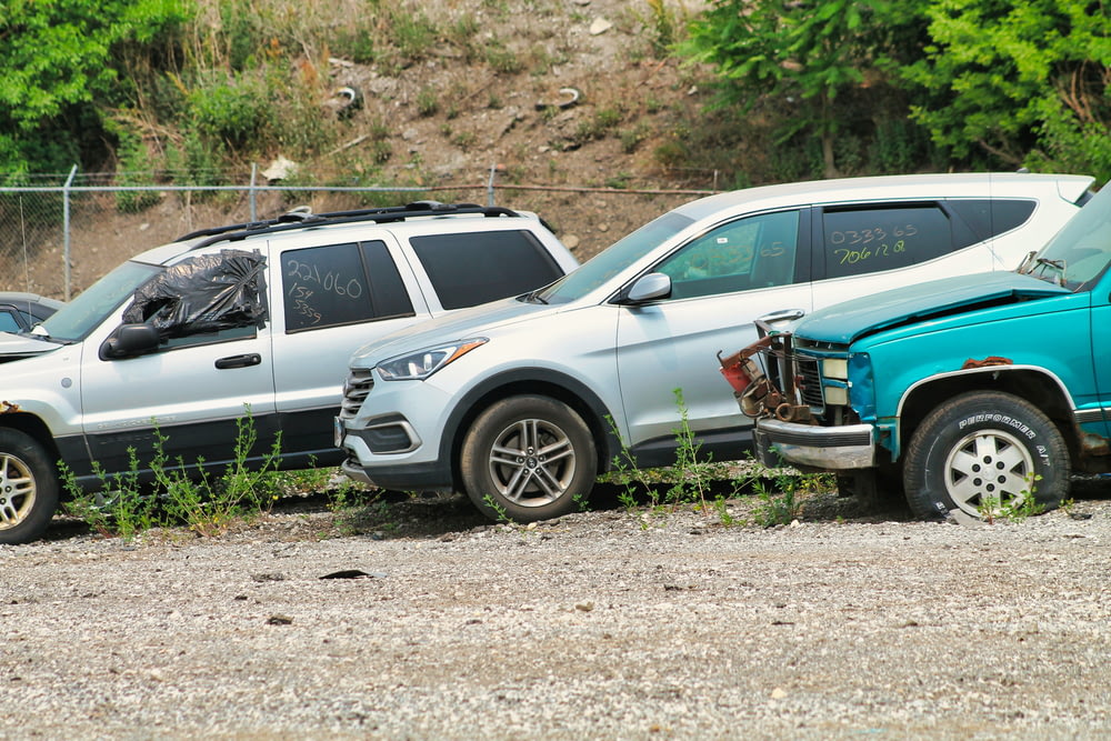 a couple of cars that are parked in the dirt