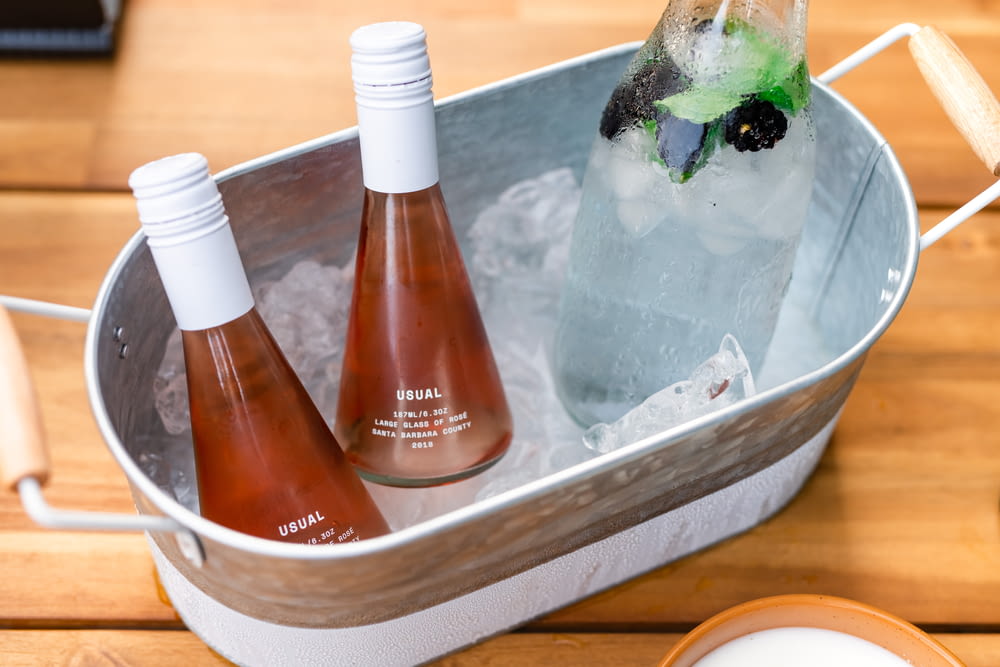 three bottles of wine in a ice bucket