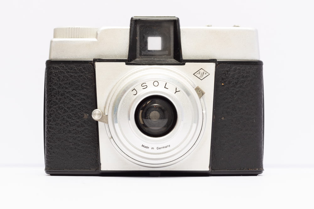 an old black and white camera on a white background