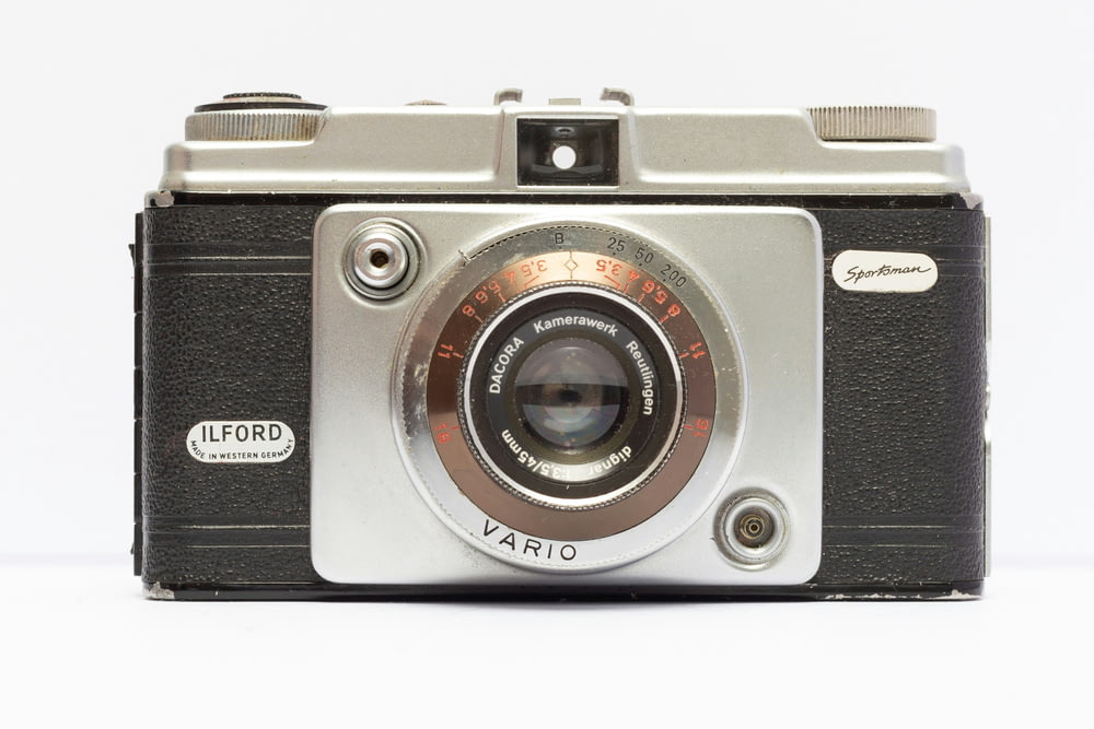 an old fashioned camera with a white background