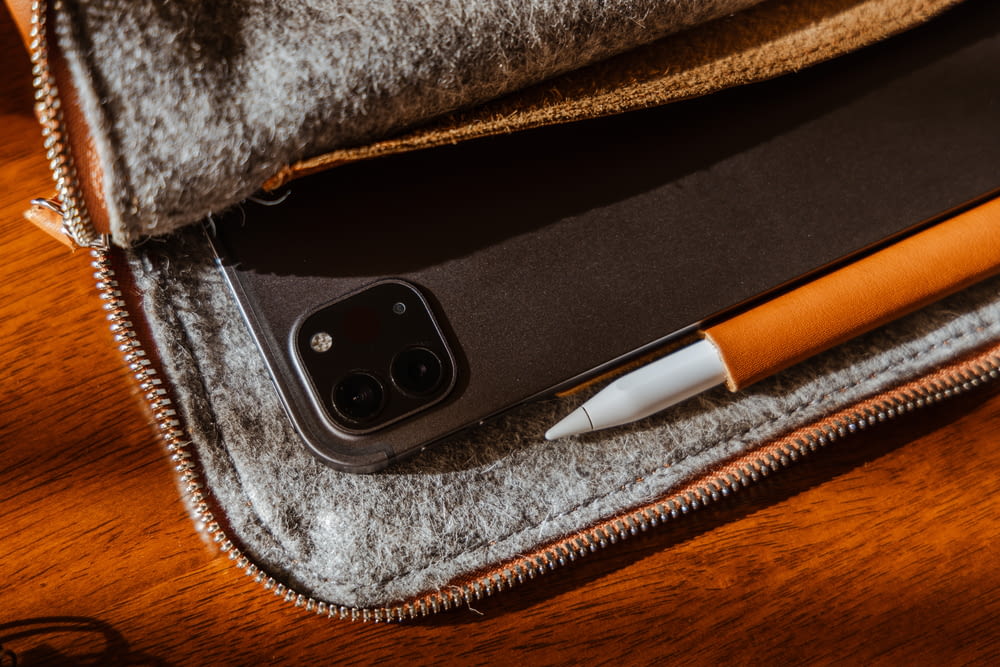 a cell phone and a pen sitting in a case