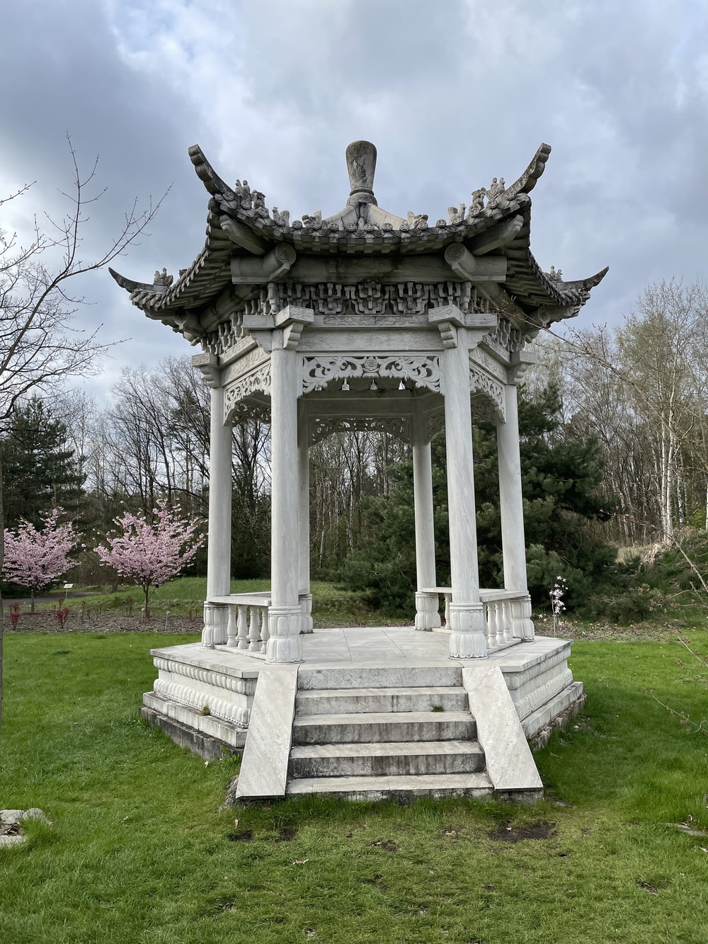 a gazebo in a park with steps leading up to it