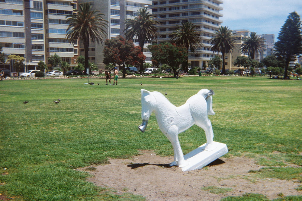 a statue of a horse in a grassy field