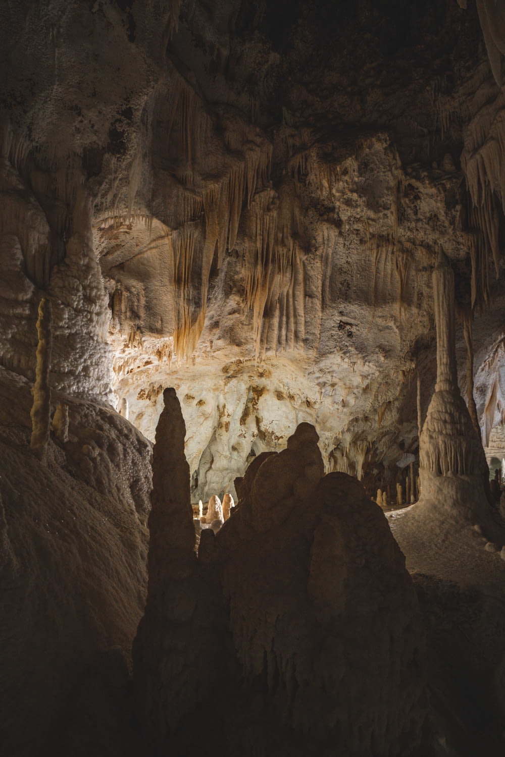 a group of people standing inside of a cave