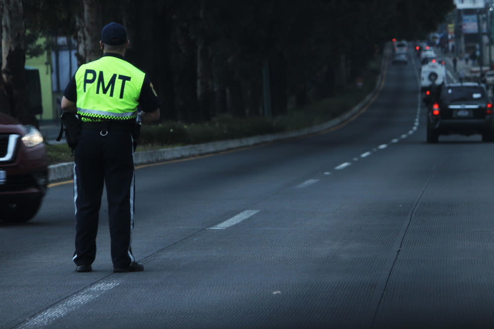 a police officer standing on the side of a road
