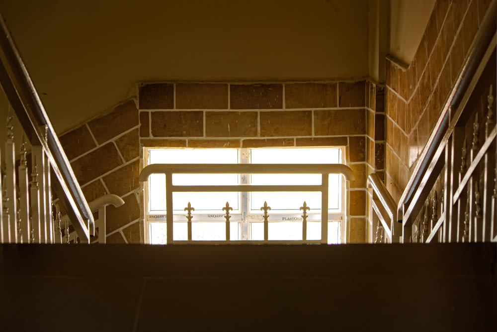 a stairway with railings leading to a window
