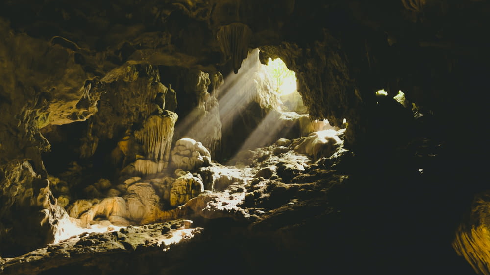 a light shines through the opening of a cave