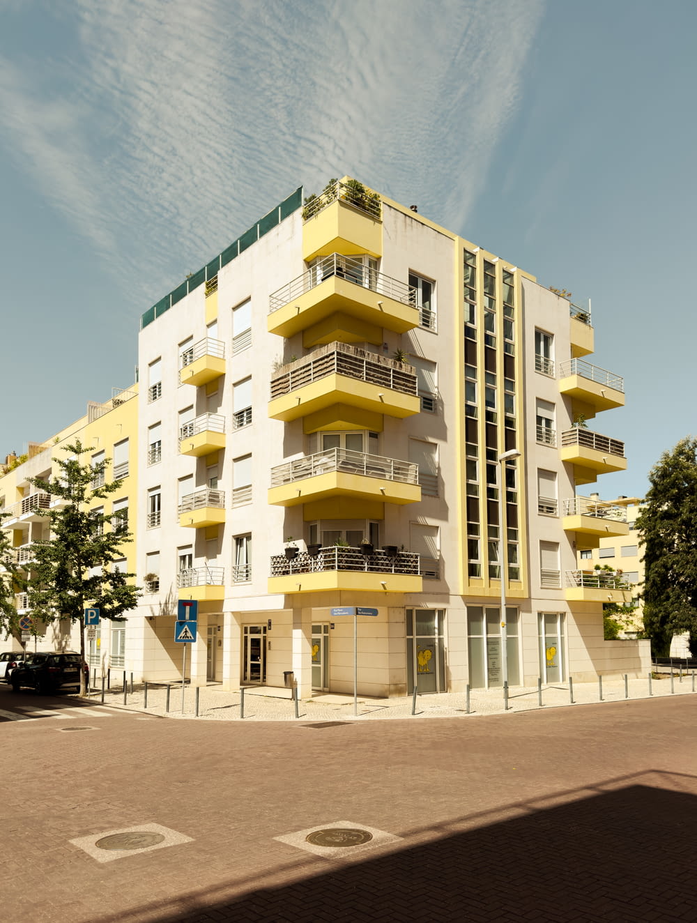 a yellow and white building with balconies and balconies
