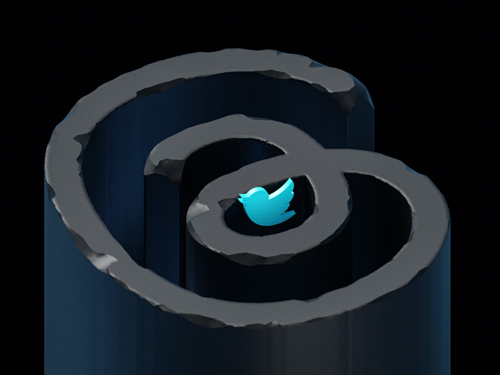 a close up of a metal object with a twitter logo on it