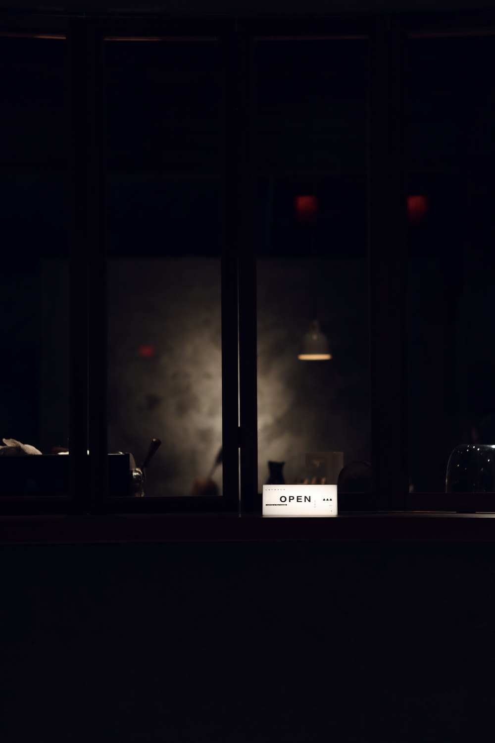 a dark room with a sign that reads open