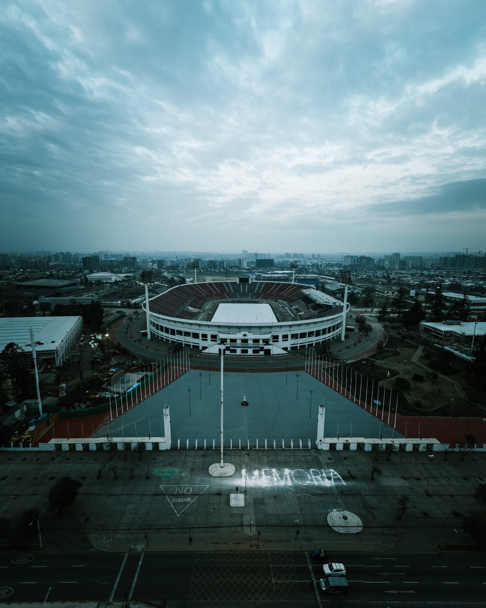 an aerial view of a stadium with a cloudy sky