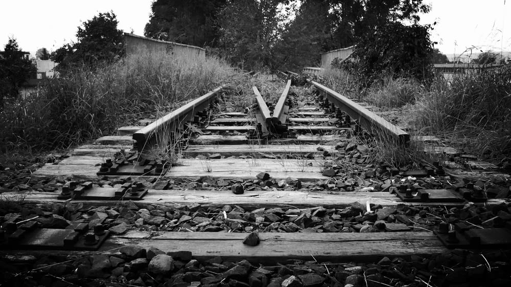 a black and white photo of a train track